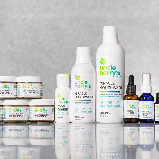 Collection of Uncle Harry's products including bottles and jars on a reflective surface with a gray background.