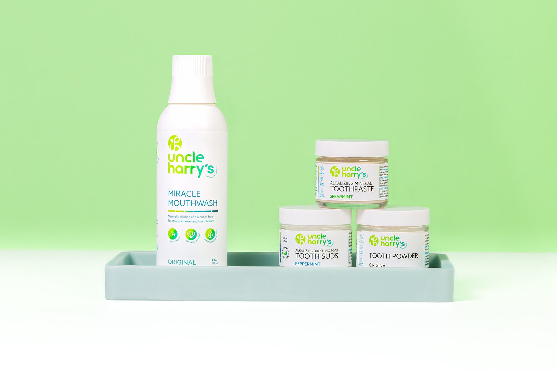 Collection of Uncle Harry's Oral Care on a white surface with a green background