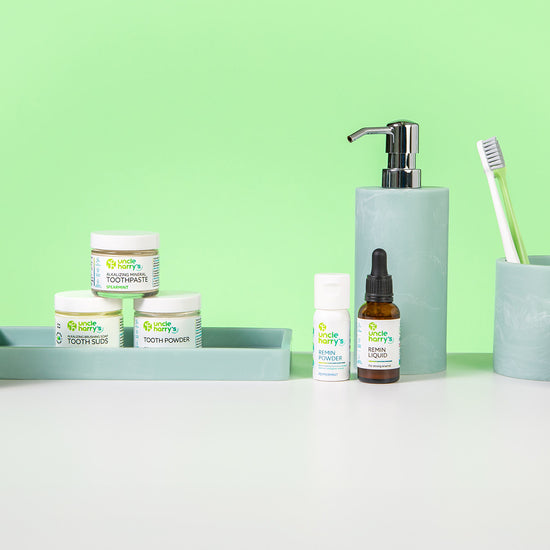Collection of Uncle Harry's Oral Care on a white surface with a green background