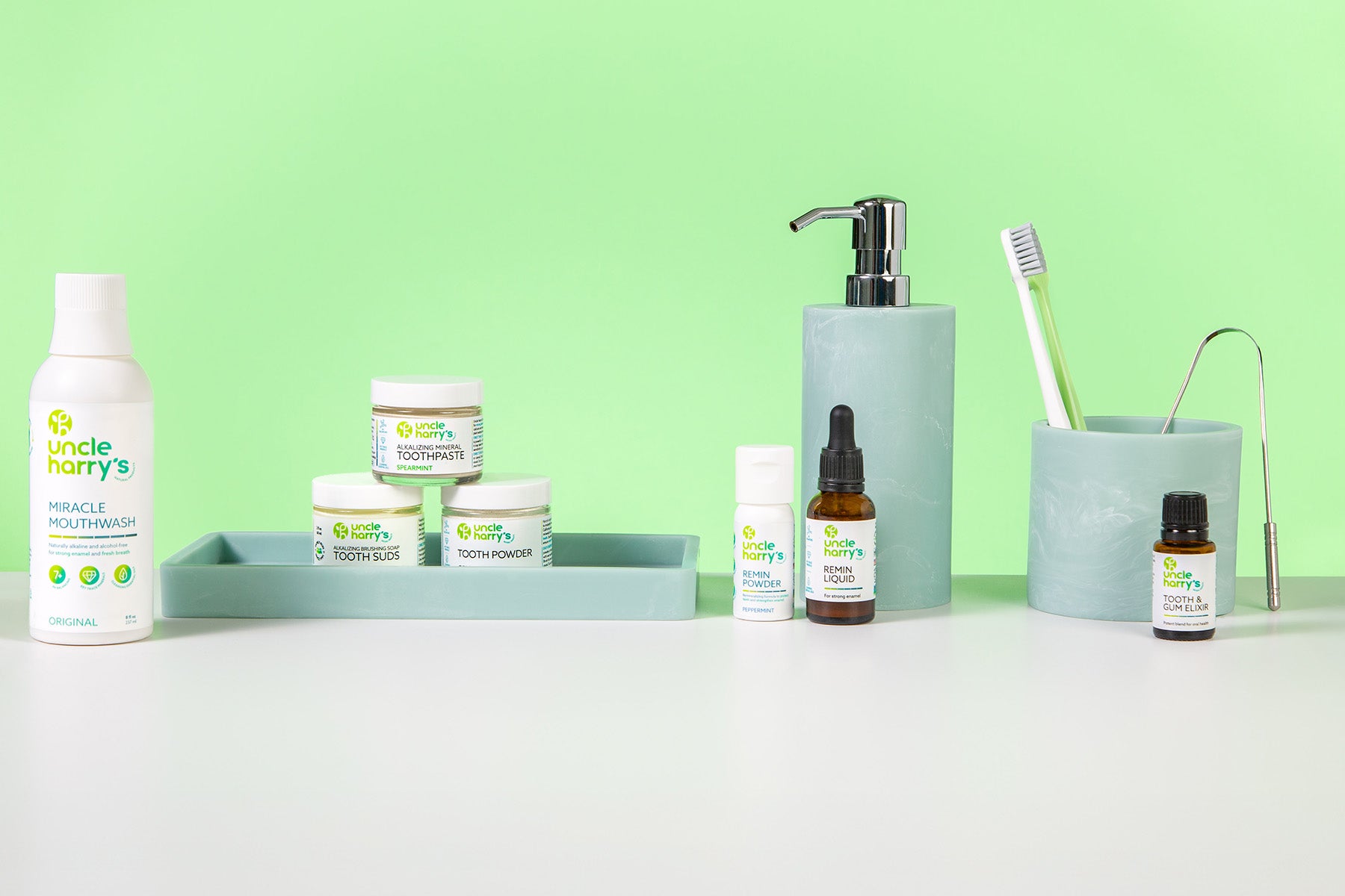Collection of Uncle Harry's Oral Care on a white surface with a green background