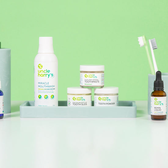 Collection of Uncle Harry's Oral Care on a white surface with a green background