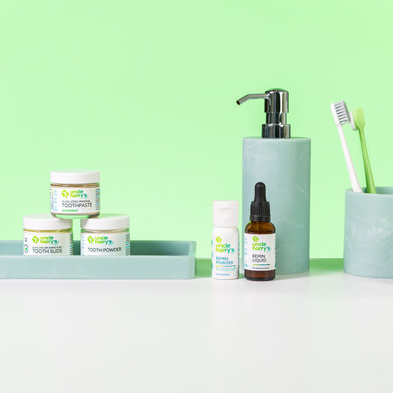 Collection of Uncle Harry's Oral Care on a white surface with a green background