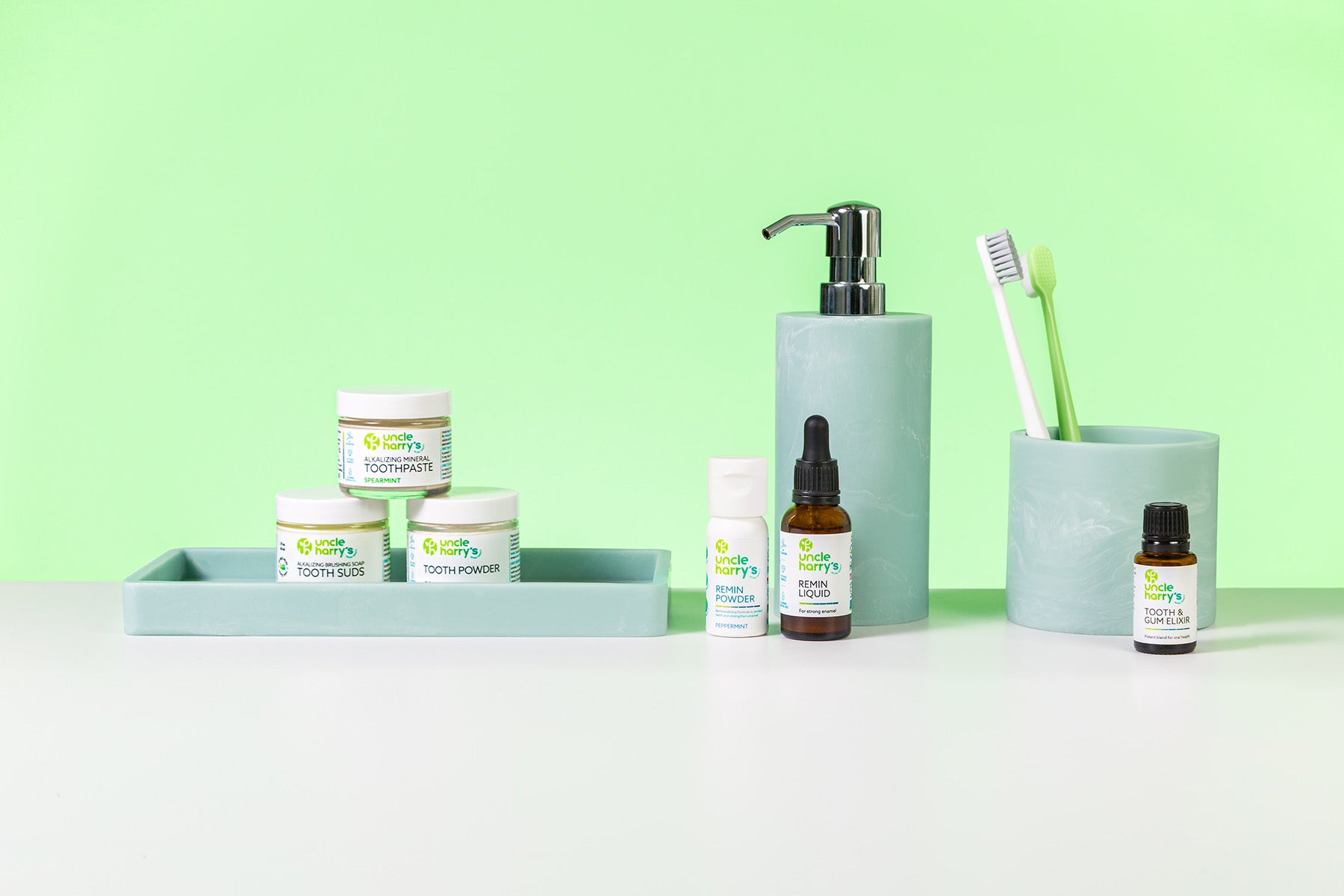 Collection of Uncle Harry's Oral Care on a white surface with a green background