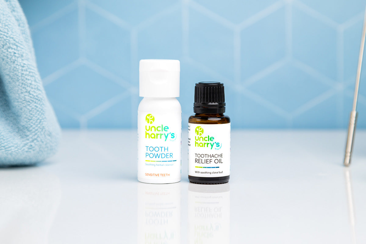 Bathroom scene with Uncle Harry's Tooth Powder for Sensitive Teeth and Toothache Relief Oil
